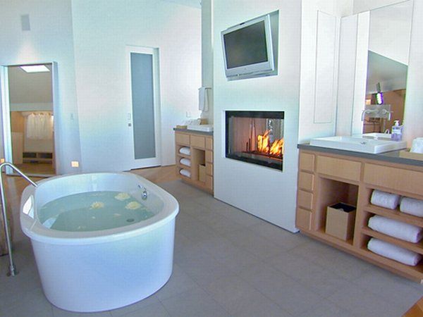 баня с дървени шкафове и голяма вана с камина